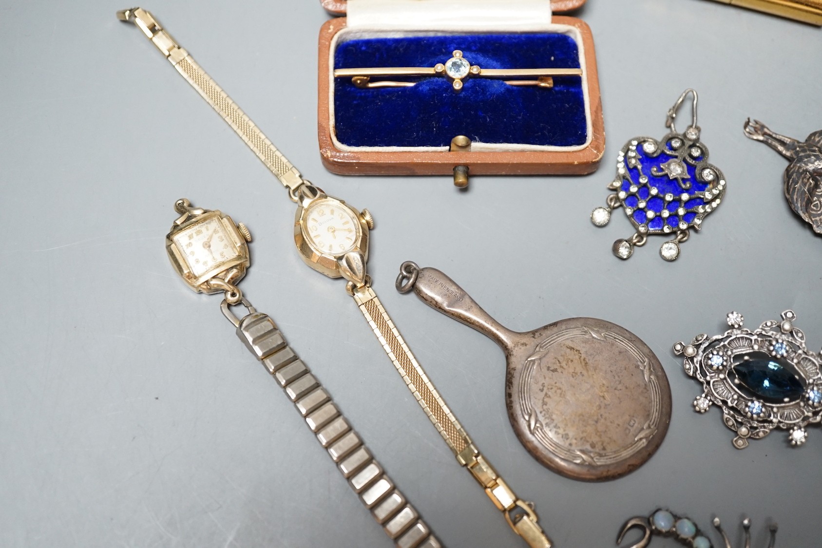 A cased Edwardian yellow metal, aquamarine and seed pearl set bar brooch, 55mm, sundry jewellery including costume, opal set scorpion brooch and enamel and paste set drop pendant and a wrist watch.